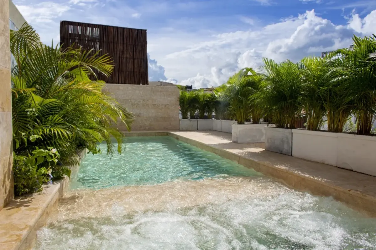 The stunning rooftop pool and lounge area of a 13-bedroom luxury villa in Cartagena, overlooking the Old Town skyline.