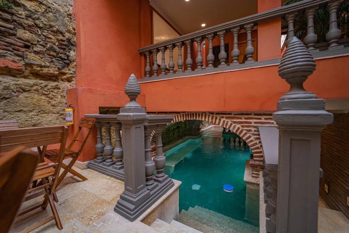 Pool terrace with colonial balustrade and brick arches