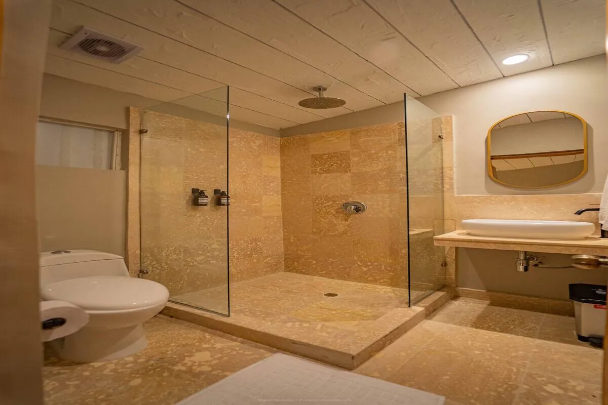 Large marble bathroom with glass shower and long vanity
