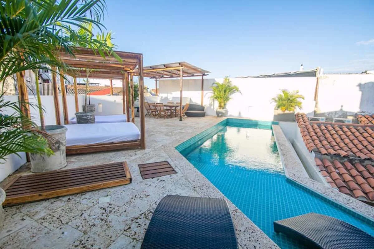 Rooftop pool terrace with daybeds and Cartagena rooftops