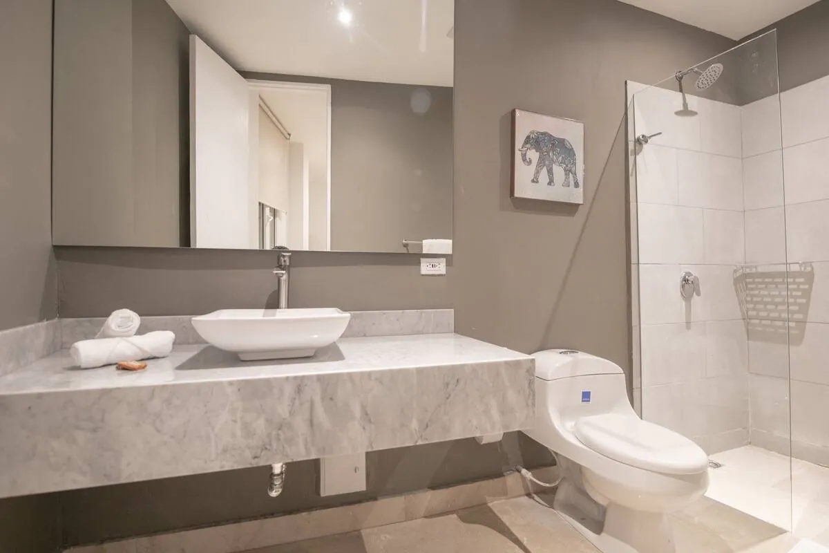 Marble bathroom with double vanity and walk-in glass shower