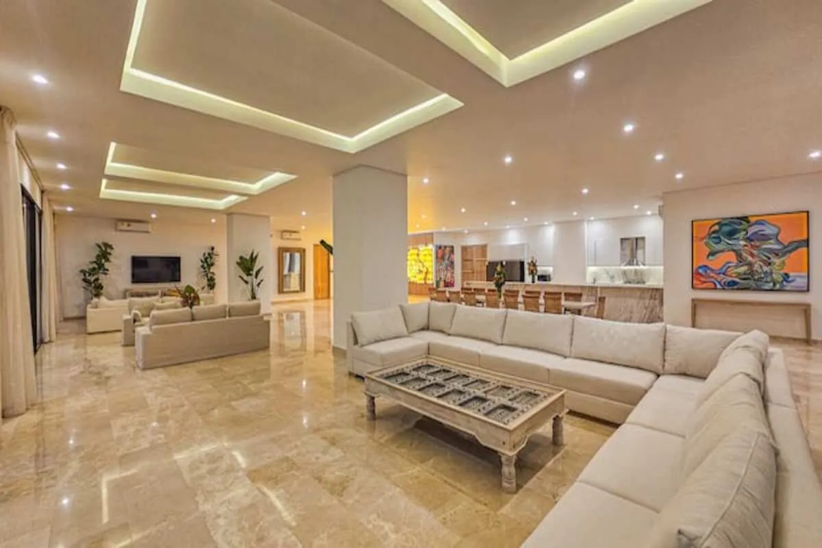 Oversized marble living room with cream sectional sofa and art walls
