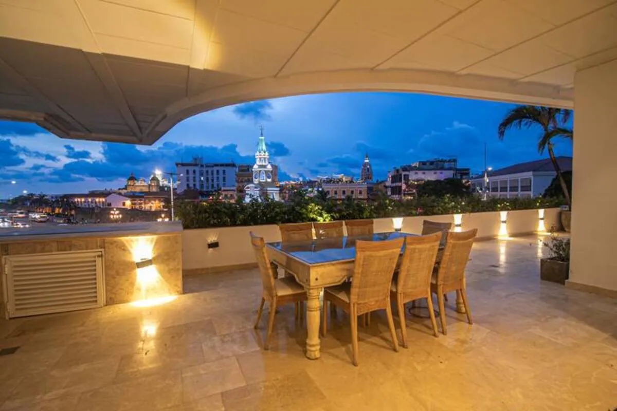 Covered rooftop dining terrace with Clock Tower view at blue hour