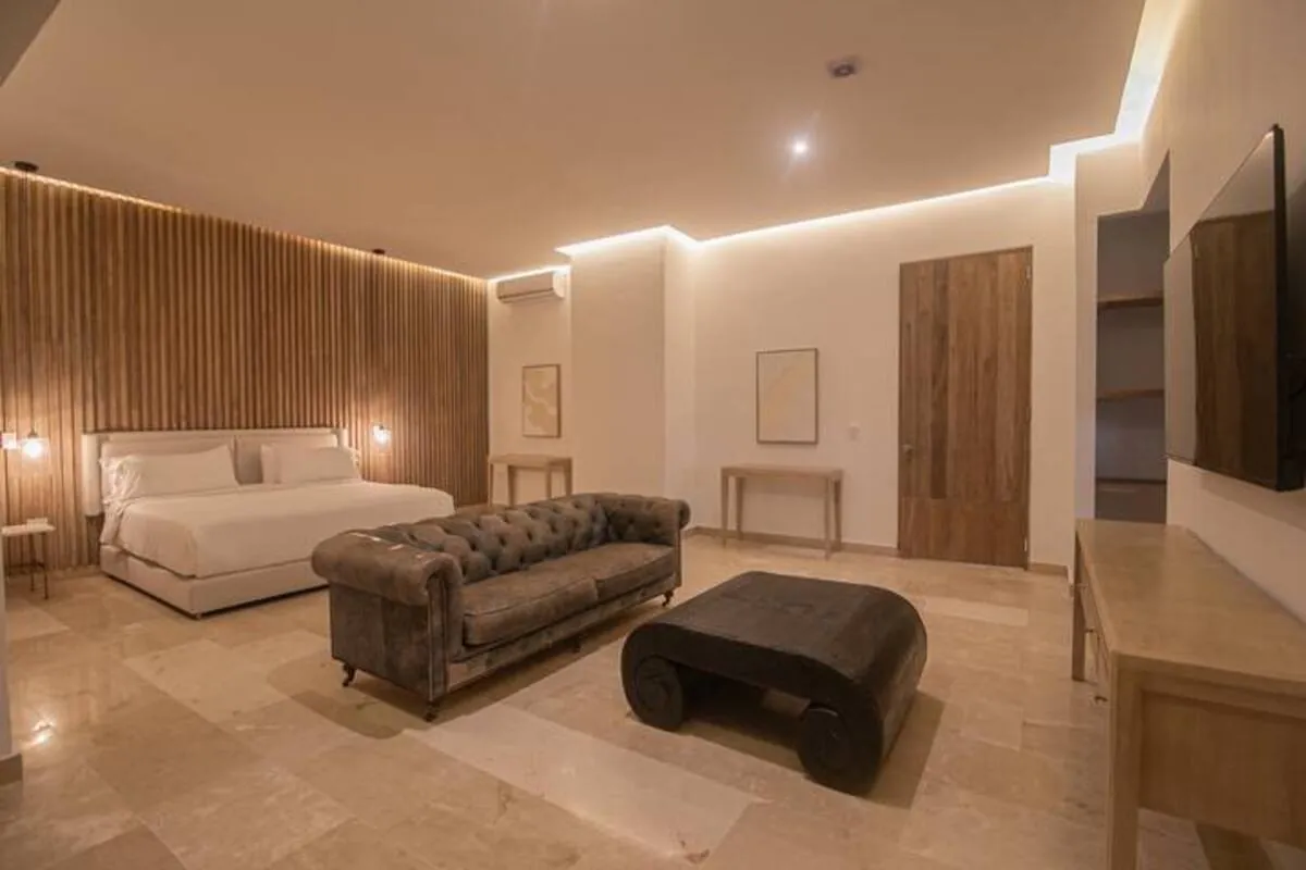 Warm TV lounge with sectional sofa, chaise seating, and wall-mounted screen
