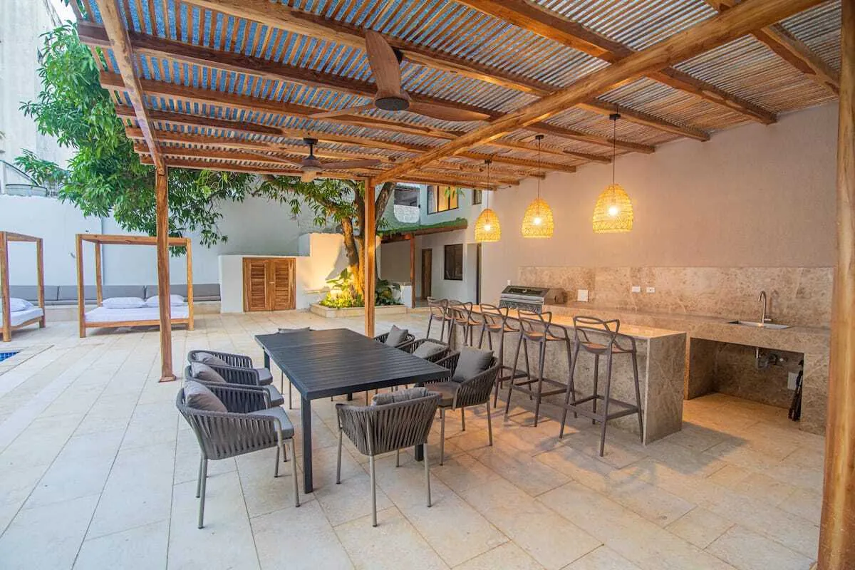 Covered outdoor bar and dining terrace with wood pergola