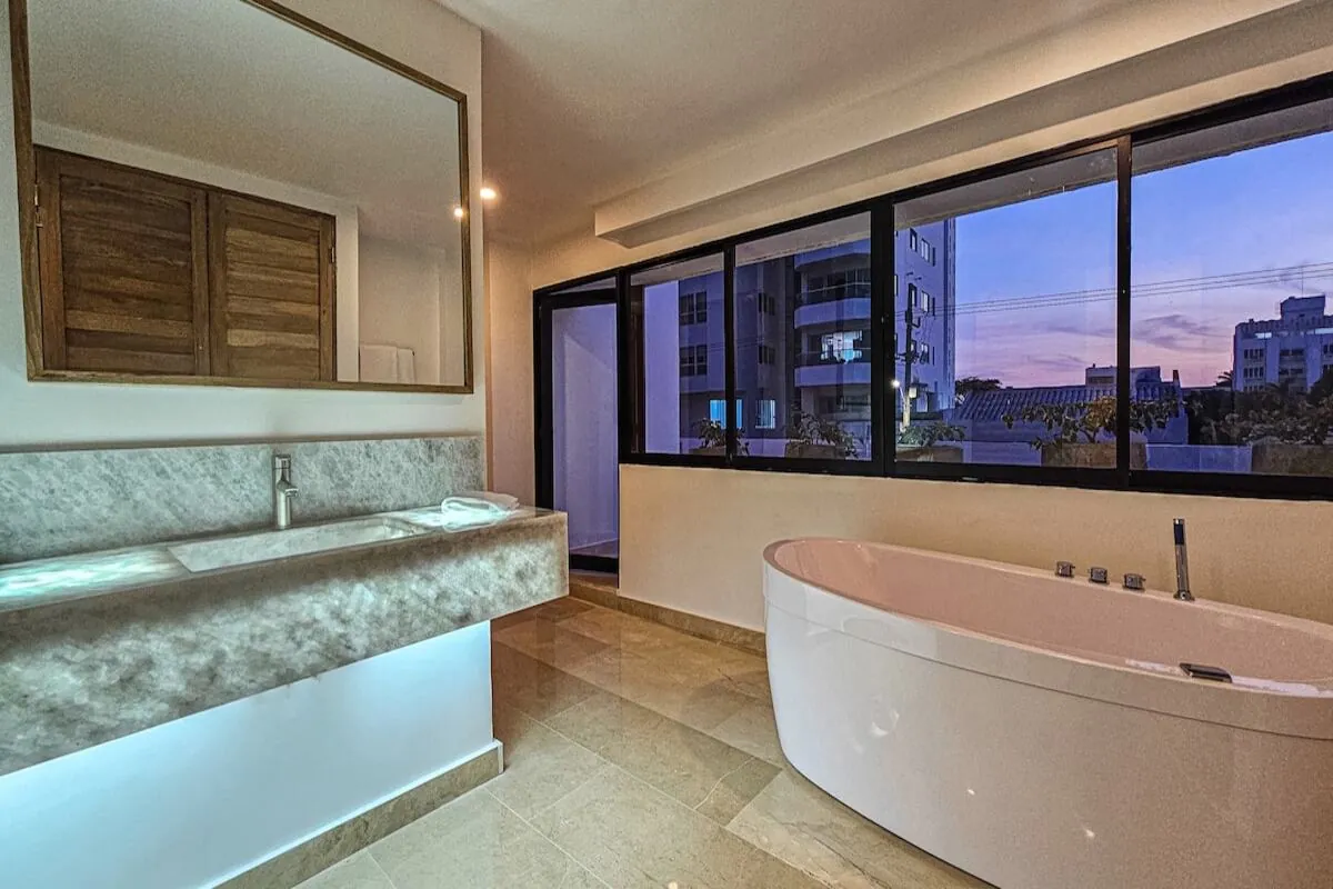 Marble bathroom with large jacuzzi tub and window views
